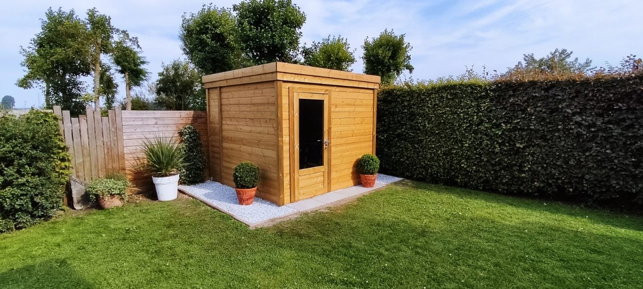 Abri de jardin bois installé dans un jardin